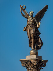 Statue of a muse on a column in Prague