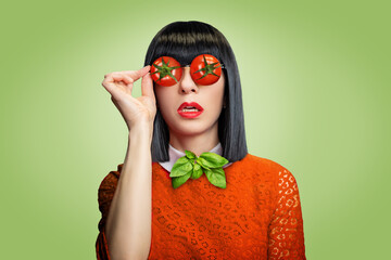 Beautiful woman in a red dress witrh tomato glasses and basil on a green background. Art