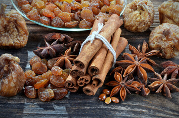 Spices cinnamon, anise stars, raisins up close, on a wooden background.Selective focus.