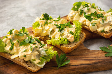 Egg salad sandwiches, on light background.