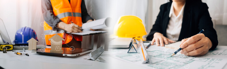Two colleagues discussing data working and tablet, laptop with on on architectural project at construction site at desk in office