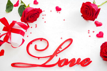 inscription love, roses, gift box, hearts on a white background. copy space..
