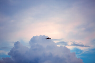 Drone doing aerial footage and in the background a sky with clouds