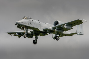 A10 tank buster jet in grey colour scheme landing on a stormy day with dark clouds