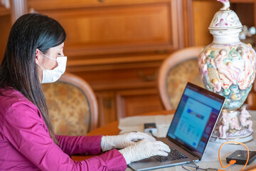 Woman working from home  wearing face mask in pandemic time