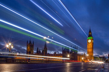 London and big ben at night. Light trails on Westminster Bridge with the houses of Parliament and...