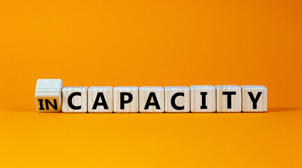 Capacity or incapacity symbol. Turned a wooden cube and changed the word 'incapacity' to...