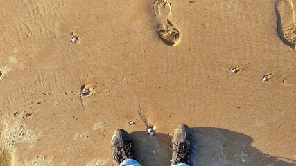 footprints and feet on sandstrad