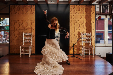 Spanish flamenco dancer on a traditional stage. - obrazy, fototapety, plakaty