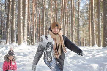 Father and daughter walking and have fun in snowy forest in winter, hiking , enjoy the snow.