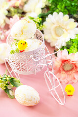 Easter floral background. Spring flowers gerbera with easter eggs on pink background.