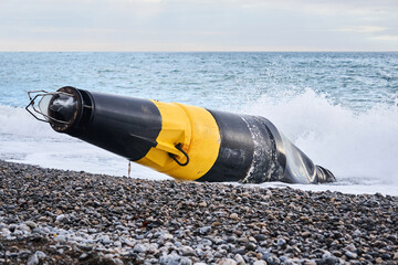 damaged sea buoy (cardinal danger mark) washed ashore after a storm