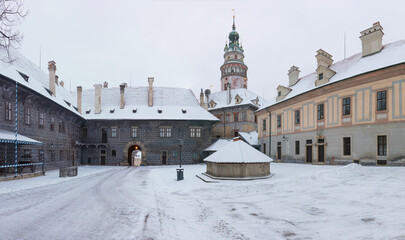 Fototapeta na wymiar Panoramic view of Cesky Krumlov in winter season, Czech Republic. View of the snow-covered roofs. Travel and Holiday in Europe. Christmas time. Historical houses and streets. UNESCO World Heritage