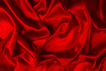 Obraz premium Red silk or satin luxury fabric texture can use as abstract background. Top view.