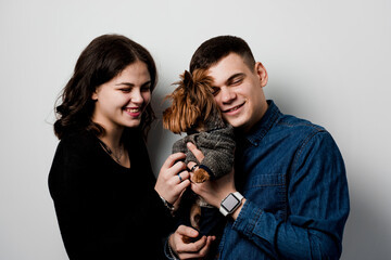 Yorkshire terrier with lovely couple on white background. Happy family with dog. Love to pets.