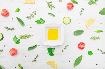 top view of various types of aromatic herb leaves and cut vegetables on wooden background