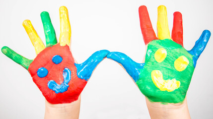 children hands in colorful paint with smiles