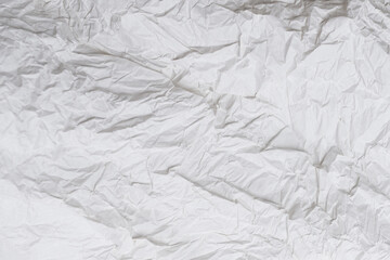 Crumpled white paper background.