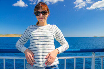 Close-up portrait of young beautiful girl traveler with white cardigan and sunglasses looking at...