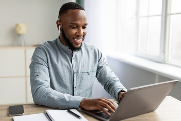 Fototapeta na wymiar Successful African Businessman Working On Laptop Sitting In Modern Office