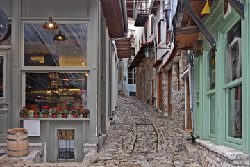 Fototapeta premium Traditional alley at Dimitsana village, an old, picturesque village in Greece, with well preserved old houses and stone paved streets.