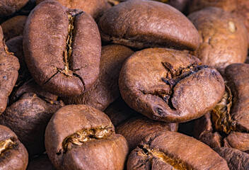 Coffee beans. Brown, roasted seeds. Coffee on a macro scale. Roasted coffee, ground beans.