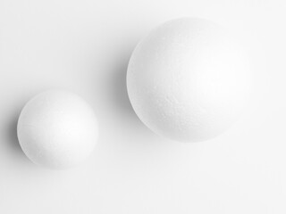 Photo two white balls,  on white paper background. Soft light study - 415632605