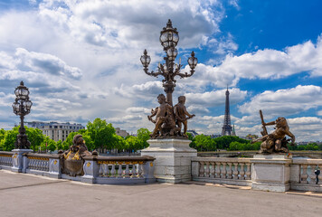 Fototapeta na wymiar Street lantern on the Alexandre III Bridge with the Eiffel Tower in the background in Paris, France. Eiffel Tower is one of the most iconic landmarks of Paris. Cityscape of Paris