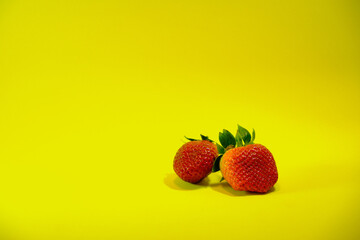 Set of strawberries on a yellow background.