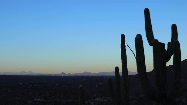 A sunrise time-lapse of Tucson and the Tanque Verde Valley as seen from the Santa Catalina mountains. Saguaro Cacti are seen in the foreground.