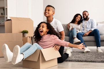 Happy African American family celebrating moving day in new apartment