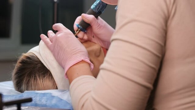 Microblading eyebrows work flow in a beauty salon. Woman