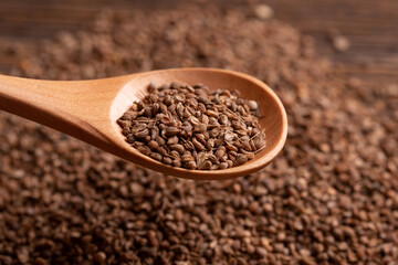 Lots of dry anise seeds. Anise seeds in a wooden spoon. Spice.