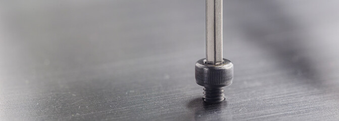 Hex wrench screw hex bolt in metal steel plate. Spanner, bolt, screw and nuts.