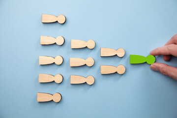 holding wooden people on table