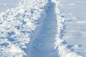 winter emergency: deep trench-trail in the snow, dug for the passage of people after heavy snowfall