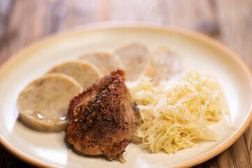 typical Czech cuisine pork with dumplings and cabbage