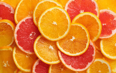 Abstract background of orange and grapefruit citrus slices on white.