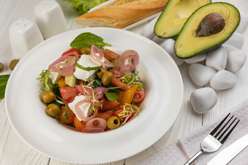 Cheese salad on a white wooden table
