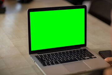 Fototapeta premium laptop with green screen in home work area. home office.