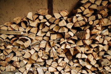 Pile of stacked triangle firewood prepared for fireplace and boiler. High quality photo