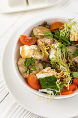 Cheese salad on a white wooden table
