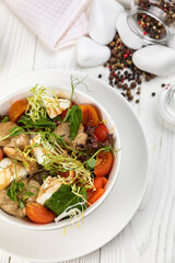 Cheese salad on a white wooden table
