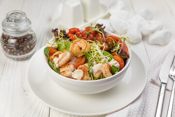 Seafood salad on a white wooden table
