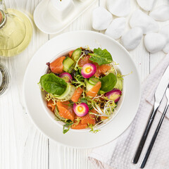 Salmon salad on a white wooden table
