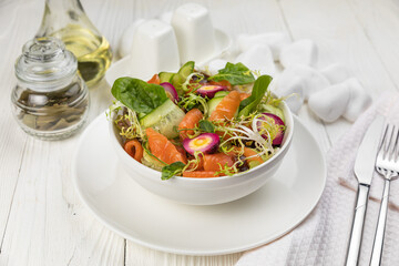 Salmon salad on a white wooden table
