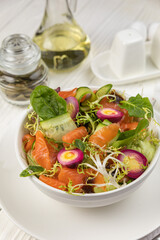 Salmon salad on a white wooden table
