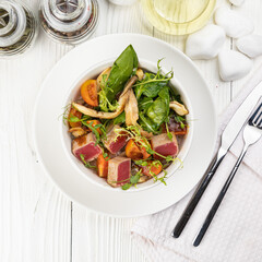 Tuna salad on a white wooden table
