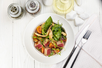 Tuna salad on a white wooden table
