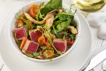Tuna salad on a white wooden table
